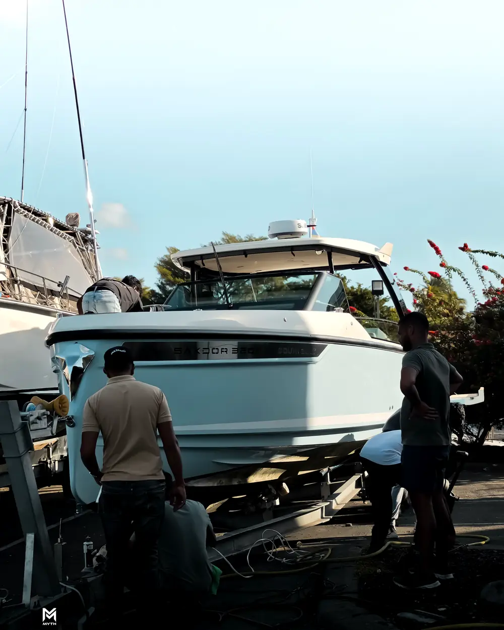 MarineXpert team detailing a Saxdor 320 on her trailer at the boatyard